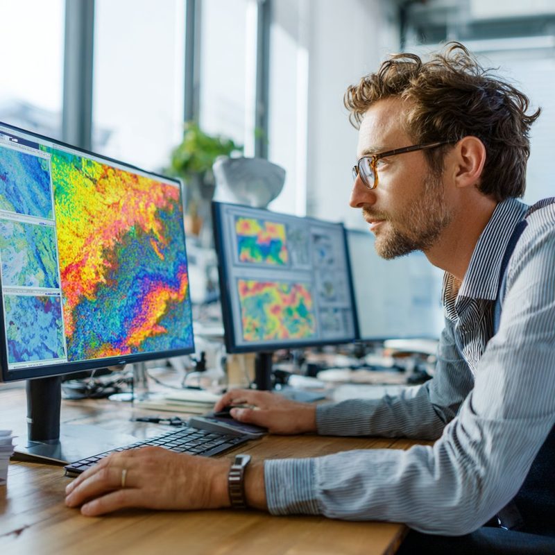 Insurance underwriter reviewing risk maps